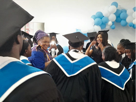 Y2K College graduation celebration with balloons and graduates